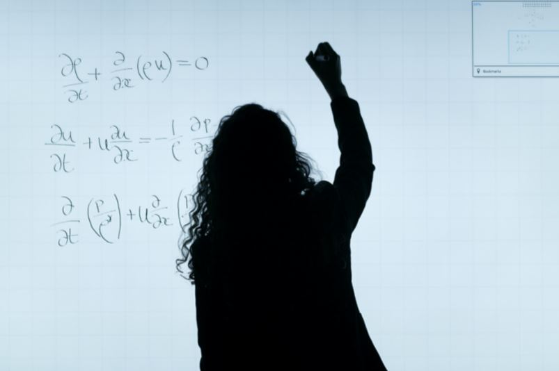 Woman in front of blackboard