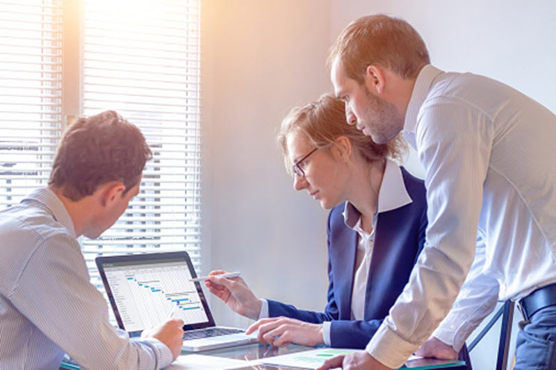 People in office viewing an Excel table