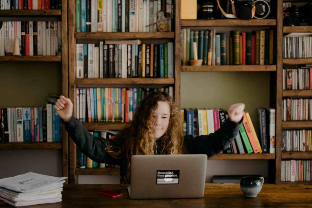 Una persona realizando una capacitación presencial en una biblioteca y se conecta a través de un computador para una capacitación online