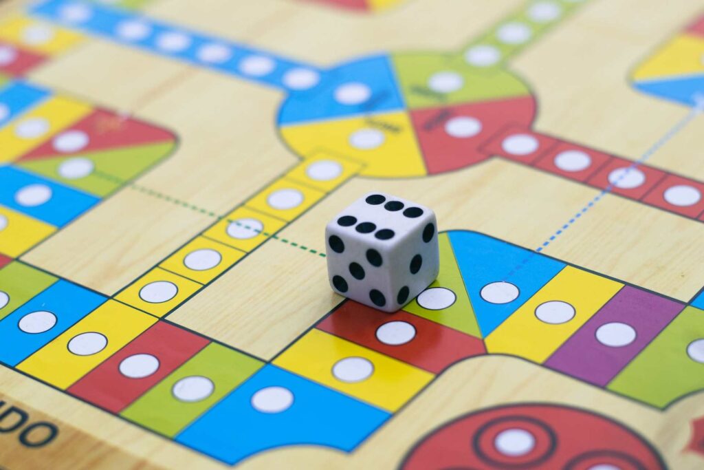 A ludo table with a dice represents a gaming experience just as gamification also represents it.